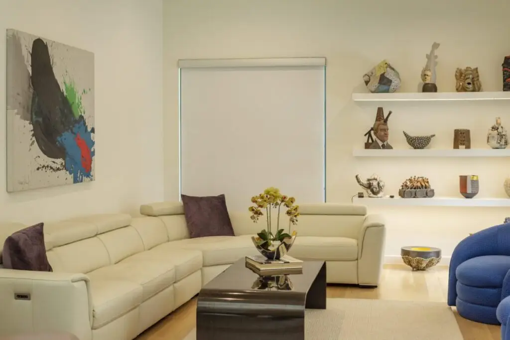 A Colourvue room-darkening roller shade installed inside a living-room window