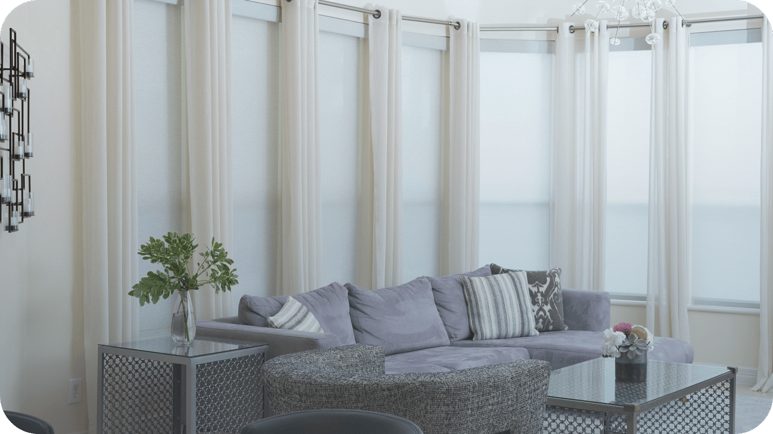 A light-filtering roller shade diffusing bright daylight into a soft even glow across a living room