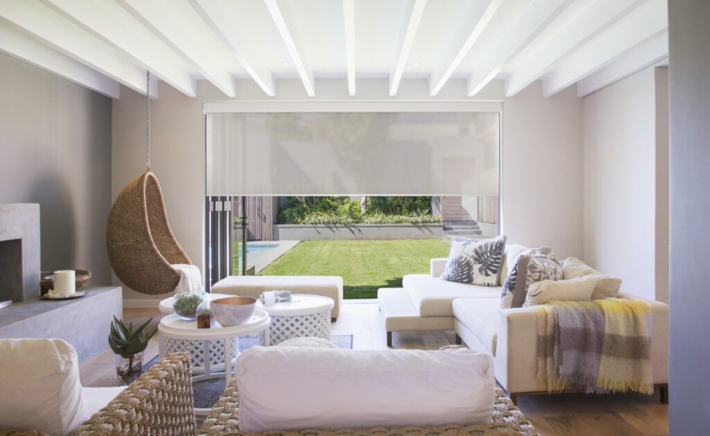 A wide Colourvue solar roller shade aligned across a large patio-door opening