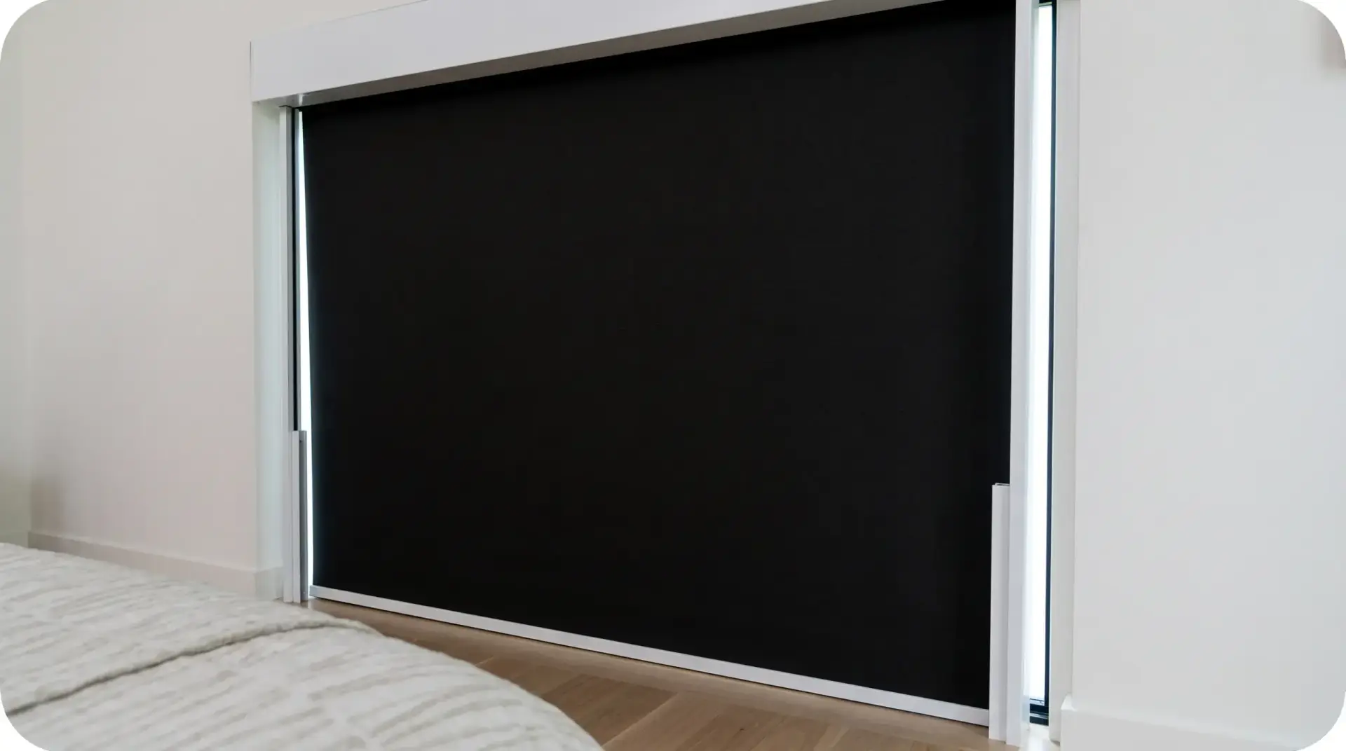 Close-up of a blackout shade with an outside mount and side channels eliminating light gaps at the window edges
