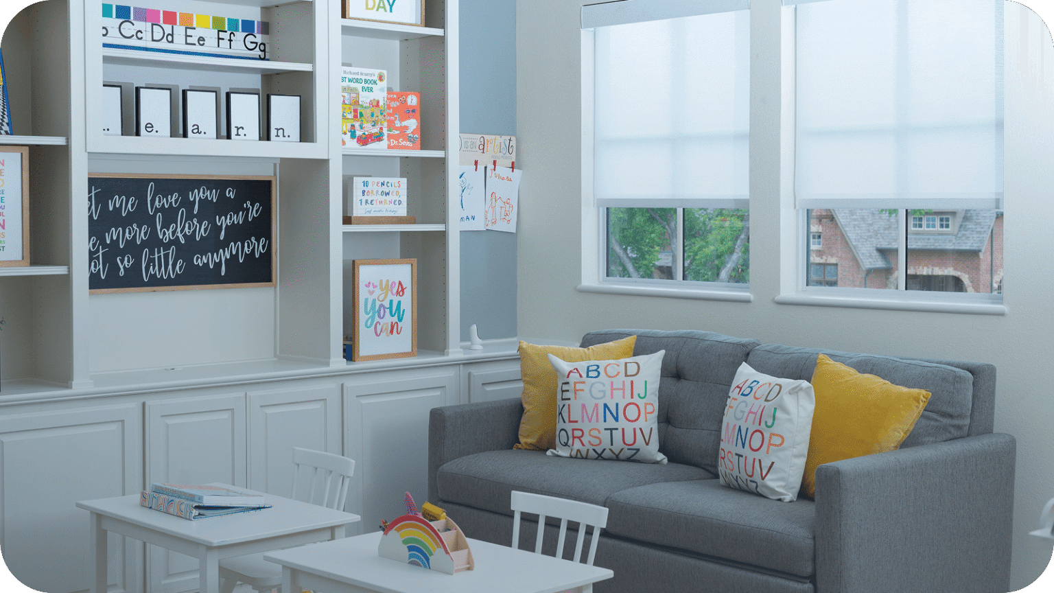 Cordless roller shades in a child's bright craft room with no hanging cords within reach