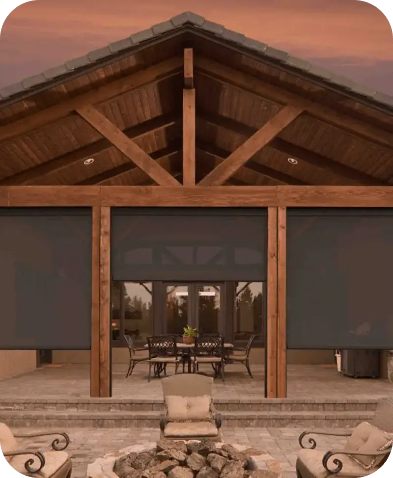 Three dark Keder outdoor shades lowered across a timber-framed patio